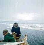 Isa and Spyglassie on a boat, Frobisher Bay, N.W.T., [Iqaluit (formerly Frobisher Bay), Nunavut] [between June-September, 1960].