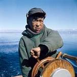 Moshah steering a boat, Frobisher Bay, N.W.T., [Iqaluit (formerly Frobisher Bay), Nunavut] [between August 9-24, 1960].