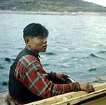 Inuit man, [Johnny Makalu (Morgan)] in a kayak, Kangiqsualujjuaq, Quebec August 1960.
