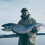 Bob Abrahamson of Minneapolis, Minn., displays a 40 lb. lake trout caught in the north of the Snowdrift river near the Indian village of Snowdrift, N.W.T. at the east end of Great Slave Lake. 1960