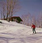 Man skiing at Mont-Tremblant, Laurentians, Quebec [Homme skiant au Mont-Tremblant, dans les Laurentides, au Québec] février 1961