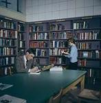 Two students in the library at Carleton University. Ottawa, Ontario. 1959
