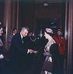 H.M. Queen Elizabeth II, being greeted by Prime Minister the Rt. Hon. John G. Diefenbaker and Mrs. Diefenbaker at a Government Reception at the Chateau Laurier, Oct. 15, 1957. Ottawa, Ont 15 octobre 1957.