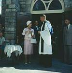 Princess Margaret holds a gift she has just received from the Rector, Rev. G.A.S. Hollywood of St. George's-in-the-Pines Anglican Church, Banff, Alta. [Entre juillet et août 1958].