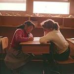 [Two girls leaning on a desk, Frobisher Bay, Northwest Territories] mai 1958.