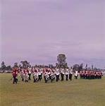 Marching band in the field followed by soldiers, during the official opening ceremonies at Upper Canada Village, on June 24th, 1961 [Fanfare suivie de soldats dans un champ aux cérémonies d'ouverture à Upper Canada Village, le 24 juin 1961] 24 juin 1961.