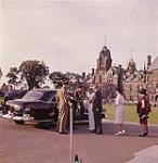 Prime Minister John G. Diefenbaker greeting Governor General Vanier on his arrival for the evening performance of the Canadian Guards at the Dominion Day ceremony. Ottawa, Ontario.   01 juillet 1961