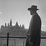 Senator James Gladstone behind the Parliament, Ottawa 1958