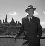 Senator James Gladstone behind the Parliament, Ottawa 1958