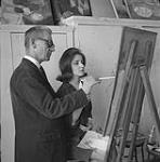 Quebec painter, Jean-Paul Lemieux showing a fellow artist some painting methods n.d.