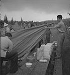 Captain of the clouds, man setting up a tent. North Bay, Ontario août 1941