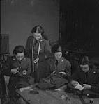 Woman's Air Force, 1940's. Unidentified Women in Uniform Cutting Material [between 1940-1949]