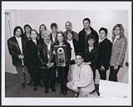 Pictured with A&M National and PGS staff, Sheryl Crow shows off her triple platinum award which makes Canada the first territory to reach triple platinum in the world for her sophomore record "Sheryl Crow". March 7, 1997. Toronto 7 mars 1997