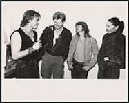 Backstage after Red Rider's show at Toronto's Kingswood Theatre the band's lead singer Tom Cochrane was greeted by Alfie Zappacosta (Surrender), Rik Emmett (Triumph) and Lisa dal Bello [entre 1986-1989].