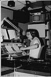 CHUM FM DJ Dan Johnson in studio speaking into a microphone. Toronto [between 1980-1990]