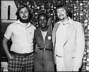 Portrait of CFTR's Red Knight with Arista's Martha Reeves. Also pictured is an unidentified man [between 1970-1980]