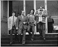 From radio CKWX, Vancouver. L to R: Peter Alpen, Tom Peacock, Bruce Bissell (A&M Records Promo Rep.), and Hoyt Axton (A&M artist) [between 1970-1980]