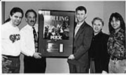 CPI Marketing Director Peter Vitols presents Toronto radio station Q-107 with a special award commemorating sales of over $1,000,000 (US) for Rolling Stones At The Max at Toronto's Cinesphere Imax Theatre. L to R: Gary Aube (Program Director), Don Shafer (President / General Manager), Peter Vitols (Marketing Director-CPI), Perry Goldberg (Marketing Director), and Joey Vendetta (Asst. Program Director / Music Director) [between 1991-1992].
