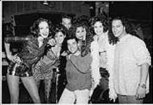 VJ Bill Welychka and A&M video guy Shawn Marino with models from Elite Model Management on the premiere of the video of Bryan Adams The Only Thing That Looks Good On Me Is You. Toronto [ca 1996]