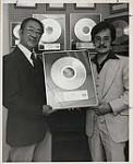 The Chows holding Lee Kramer's MCA Award for the song and / or album Don't Stop Believin.' 1977