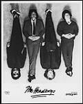 Press portrait of The Headboys lying on the ground ca. 1980.