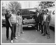 Helix wearing suits during a visit to the CHUM-FM radio station: (l to r) Brian Vollmer, Steve McAuley (Capitol Records-EMI Canada Promotion Rep), Paul Hackman, Brent Doerner, Daryl Gray, Greg Hinz - Toronto [between 1983-1990].