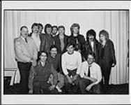 Hall and Oates meeting with members of RCA Canada in Toronto following the band's double platinum presentation: (front row) Peter Piasecki (RCA Ontario Sales Rep), Jim Campbell (Manager/Artist Development), Ralph Dunning (Ontario Field Merchandiser), Kevin Shea (Ontario Promotions Rep), (back row) Kenny MacGregor (Ontario Sales Rep), Terry Carson (Ontario Sales Manager), Ron Solleveld (Director of Music Publishing), Ken Bain (National Promotions Manager), Greg Pappas (Ontario Sales Rep), Jim Fotheringham (Director of A&R), Daryl Hall, John Oates, Tracy Keizer (Administrator of Press Relations) [ca. 1984].