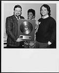 Portrait of Anita Baker, Garry Newman (WEA Canada VP Sales), and David Bither (Elektra International VP) after a sold out performance at Toronto's O'Keefe Centre where Baker accepted a Canadian Gold Award for her debut album Rapture [between 1986-1987].