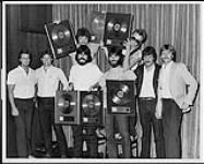 Portrait of RCA supergroup Alabama after receiving platinum and gold records for Roll On (their fifth album for RCA). Calgary [between 1984-1985].