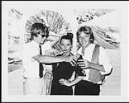 Portrait of Cherrill and Robbie Rae and Bryan Adams. The Raes took time out from the taping of their CBC TV series in Vancouver to toast the success of Adams' Let Me Take You Dancing. A&M Publicity July, 1979
