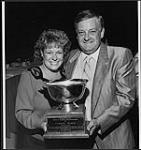 Carroll Baker at the Canadian Country Music Awards accepting the Martin Guitar Award from President of Martin Canada, Bill Locke. The award is given for outstanding annual contribution to the advancement and promotion of country music in Canada 1989