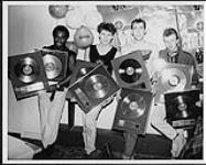 Portrait of the band Big Country upon receiving Gold and Platinum awards for their album The Crossing. Montréal's Le Spectrum [ca 1983-1984]