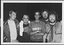 Portrait of CFTJ's Greg "Sharky" Schartzbert, Gary Peterson, Dan Murphy, CFTJ's assistant Program Director and the show's host, Randy Bachman and brother Tim [between 1980-1987].