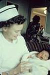 Nurse holding newborn baby, Fort Qu'Appelle, Saskatchewan n.d.