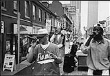 Earthtones, R & B group from Calgary, performing from a truck on a busy street [entre 1992-1997].