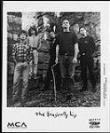 Publicity portrait of The Tragically Hip standing in stone ruins décembre 1994