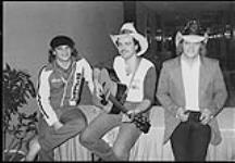 At a taping of "Opry North" - (left to right) Shawn Kelly (of Gunsmoke), Colin Butler (of Burco Records), Danny Thompson (of Bel Air) [entre 1985-1990].
