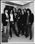 The Tragically Hip posing with members of Aerosmith following the Juno Awards - (left to right) Gord Sinclair, Joe Perry, Gord Downie, Steven Tyler, Johnny Fay, Bobby Baker, Paul Lanlois [ca 1990].