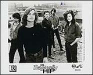 Publicity portrait of The Tragically Hip standing on a rooftop s.d.
