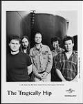 Publicity portrait of The Tragically Hip in front of oil storage tanks - (left to right) Johnny Fay, Rob Baker, Gordon Downie, Paul Langlois, Gord Sinclair mai 1998