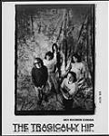Publicity portrait of The Tragically Hip in front of a fabric backdrop août 1989