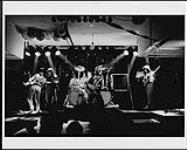 Triumph performing at their 8th birthday party held at Knob Hill Tavern on November 12, 1983 - (left to right) Rick Lazaroff, Rik Emmett, Mark Santers, Rick Derringer, Rick Santers November 12, 1983