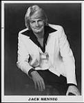 Press portrait of Jack Hennig wearing a white suit jacket and vest [between 1973-1978].