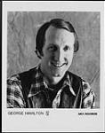 Press portrait of George Hamilton IV wearing a plaid shirt and leather vest [ca. 1979].
