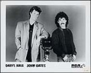 Press portrait of Hall and Oates with a camera: Daryl Hall, John Oates [between 1975-1980].