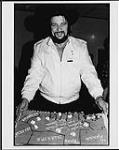 Waylon Jennings celebrating his birthday backstage at Hamilton Place with a Texas-shaped cake [between 1981-1990].