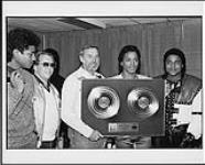 The Jacksons receiving a double platinum award for "Victory": (l to r) Jackie Jackson, Don Oates (VP of Sales and Marketing, CBS Canada), Bernie Dimatteo (President, CBS Records Canada), Marlon Jackson, Tito Jackson [ca. 1984]