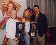 Mariah Carey receiving two album awards and posing with Rick Camilleri (Sony Music Entertainment Inc., Canada) and an unidentified man [ca. 2000].