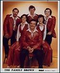 Photo publicitaire de Family Brown portant des costumes en cuir assortis [between 1977-1983].