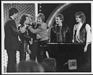 Loverboy accepting an award on stage [ca. 1981].